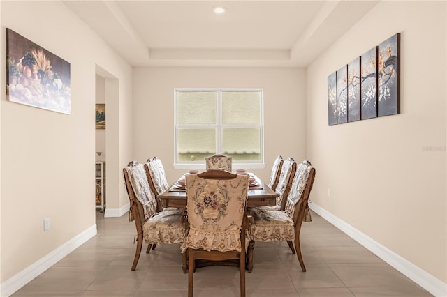 dining area with a raised ceiling