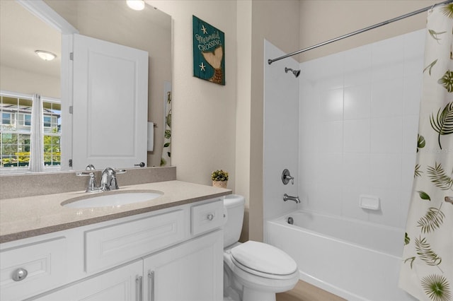 full bathroom featuring vanity, shower / bathtub combination with curtain, and toilet