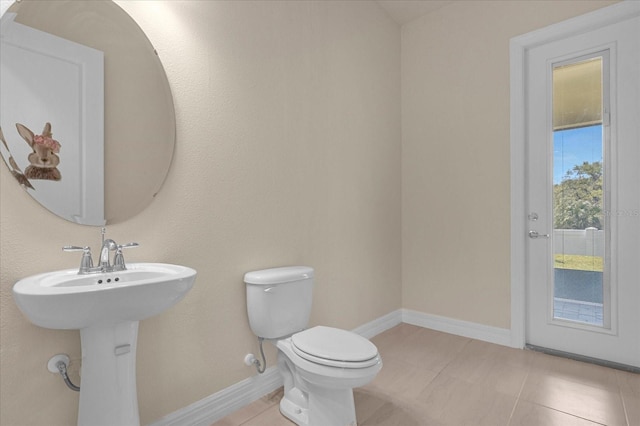 bathroom with sink, tile patterned floors, and toilet