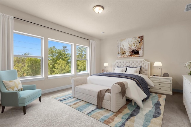 carpeted bedroom featuring a textured ceiling