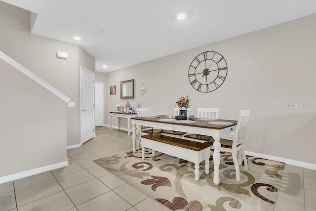 dining space featuring light tile patterned flooring