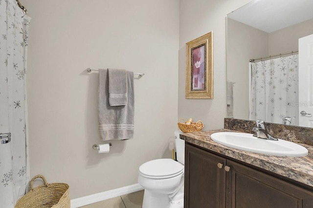 bathroom with vanity, tile patterned flooring, and toilet