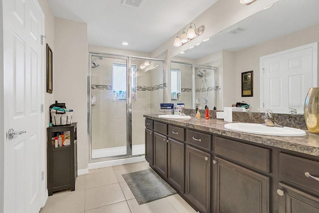 bathroom featuring tile patterned flooring, vanity, and walk in shower