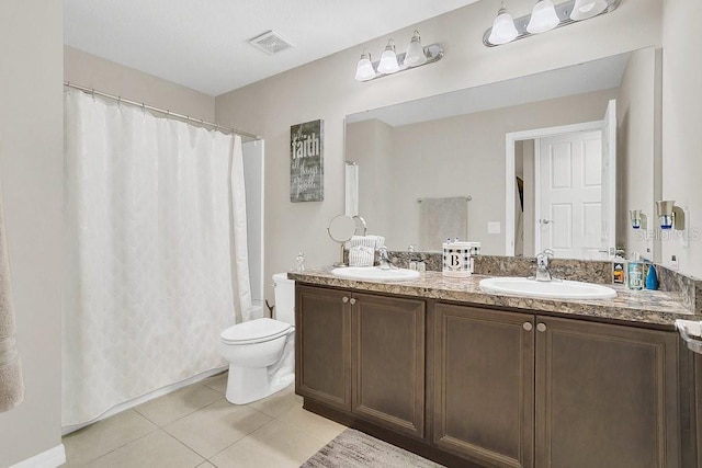 bathroom with vanity, tile patterned floors, and toilet