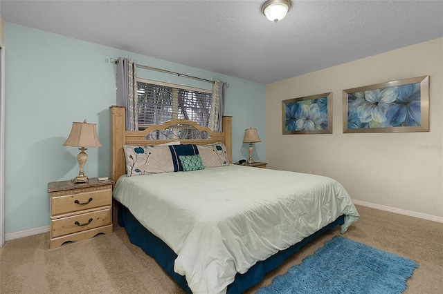 bedroom featuring a textured ceiling and carpet