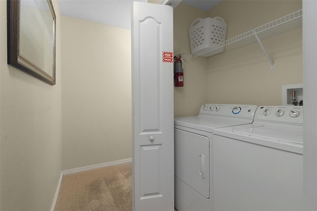 clothes washing area with washing machine and dryer, carpet, and washer hookup