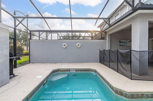 view of swimming pool featuring a lanai