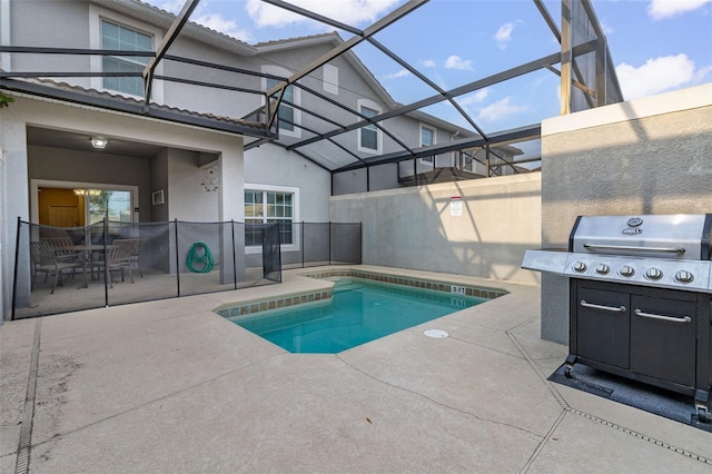 view of pool with a patio area and a lanai