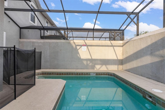 view of swimming pool with a lanai