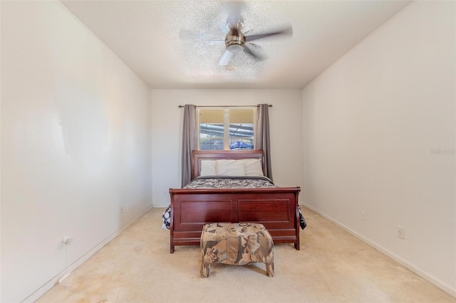 carpeted office space with ceiling fan and a textured ceiling