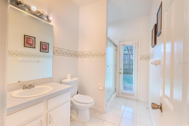 bathroom featuring tile patterned floors, vanity, toilet, and a shower with shower door