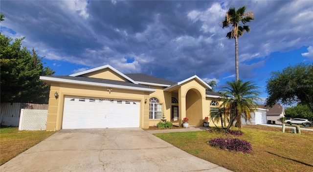 ranch-style house with a garage and a front lawn