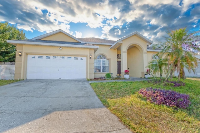 view of front of house featuring a garage and a front lawn