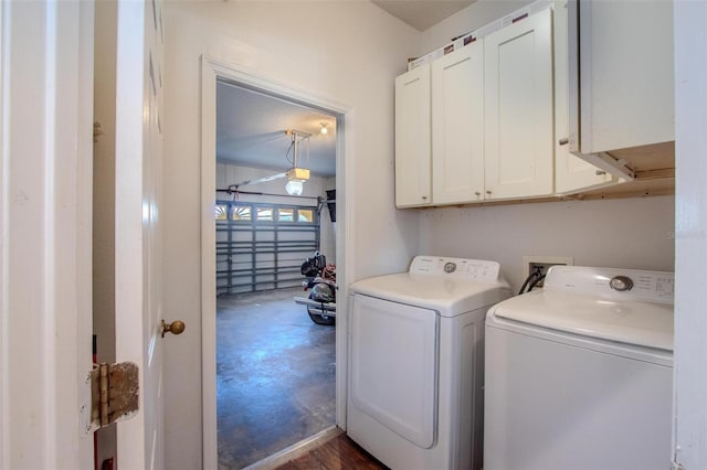 clothes washing area featuring cabinets and independent washer and dryer