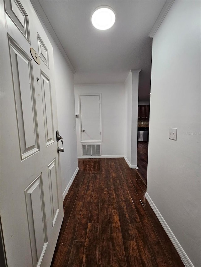 hall with crown molding and dark hardwood / wood-style flooring