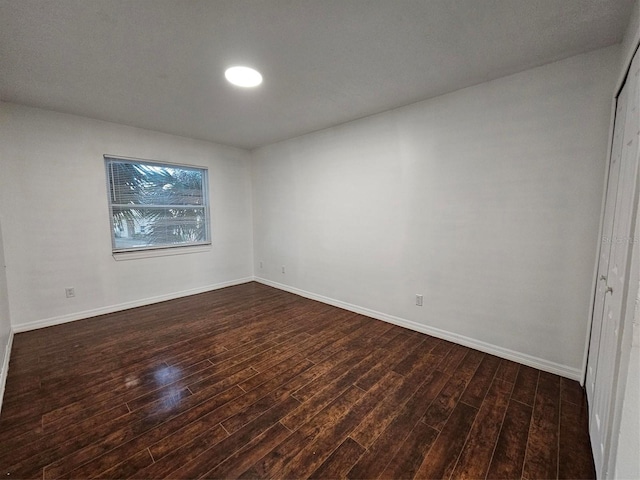 spare room featuring dark wood-type flooring