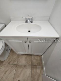 bathroom with tile patterned floors, vanity, and toilet