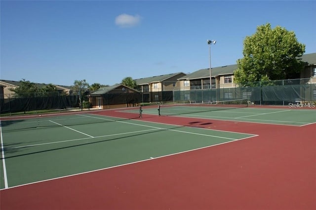 view of tennis court featuring basketball court