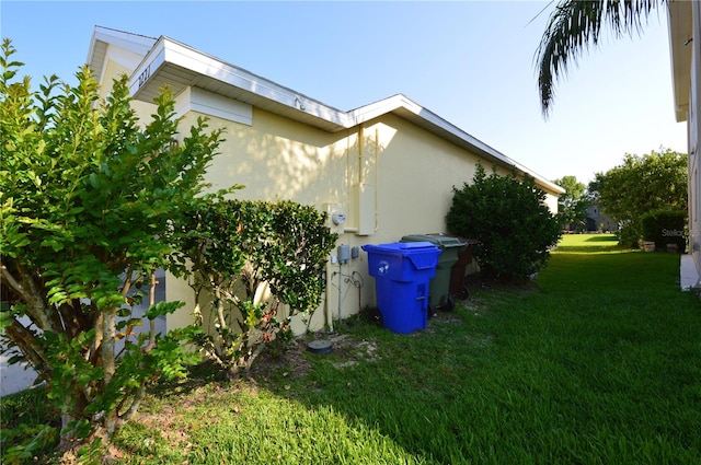 view of side of home with a lawn