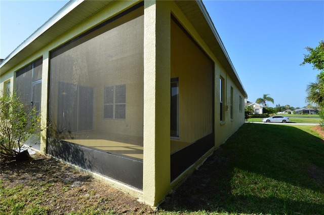 view of side of home with a yard