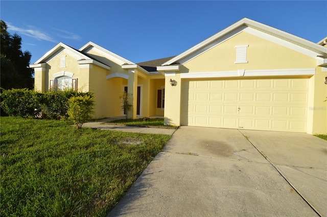 ranch-style house featuring a garage, driveway, and stucco siding