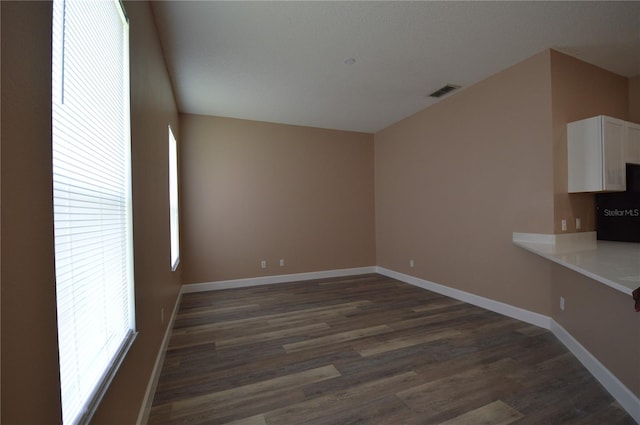 unfurnished living room featuring dark wood-type flooring