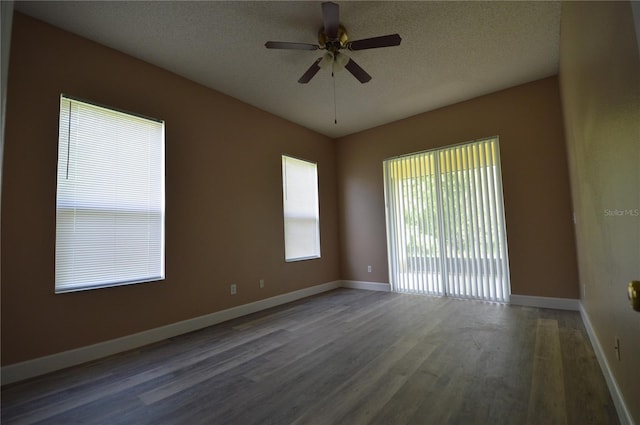 unfurnished room with a textured ceiling, dark hardwood / wood-style flooring, and ceiling fan