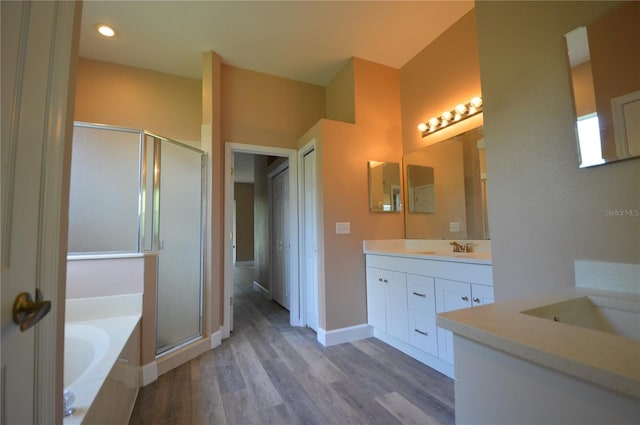 bathroom featuring vanity, shower with separate bathtub, and hardwood / wood-style floors