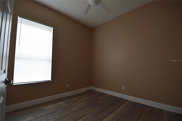 unfurnished room featuring ceiling fan, dark hardwood / wood-style floors, and plenty of natural light