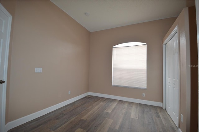 unfurnished bedroom featuring wood-type flooring and a closet