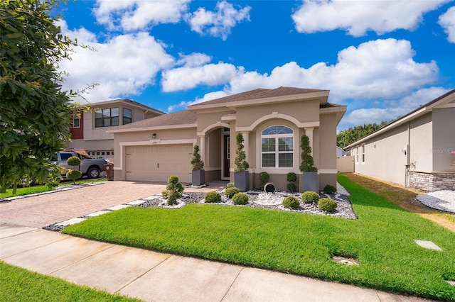 mediterranean / spanish house with a garage and a front lawn