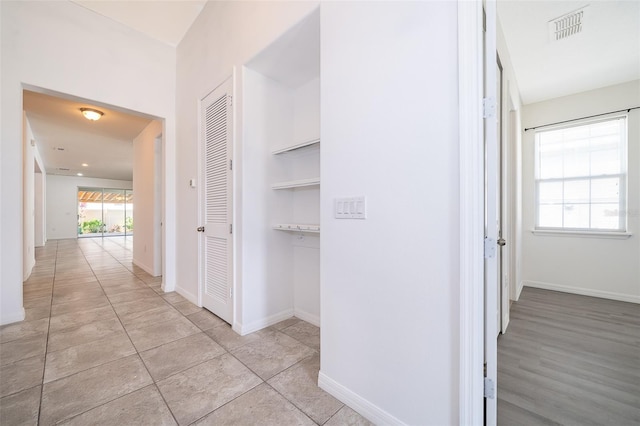 hallway featuring light tile floors