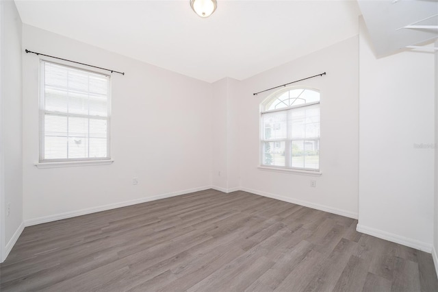 unfurnished room featuring hardwood / wood-style flooring