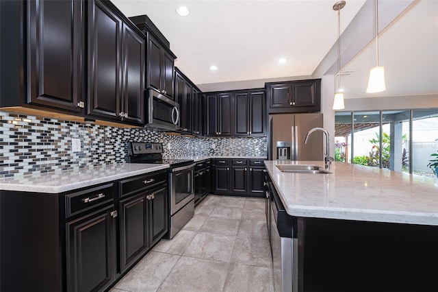 kitchen with decorative light fixtures, backsplash, stainless steel appliances, light tile flooring, and sink