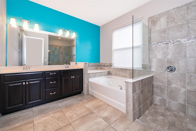 bathroom with oversized vanity, tile floors, double sink, and shower with separate bathtub