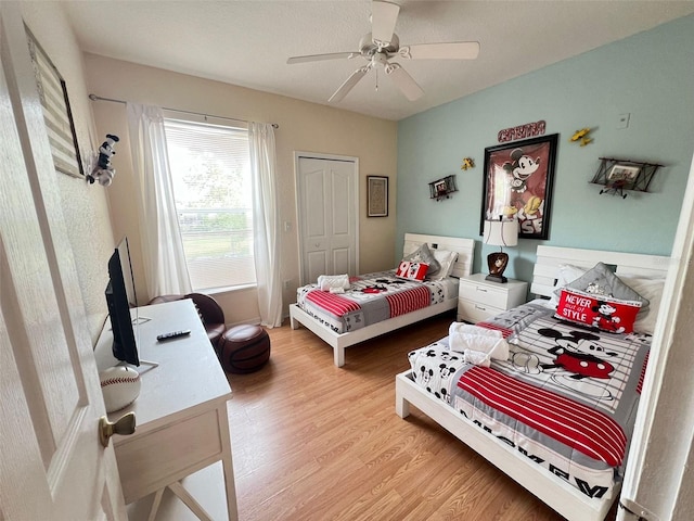 bedroom featuring ceiling fan, a closet, and hardwood / wood-style floors