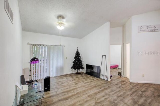 interior space with hardwood / wood-style flooring and a textured ceiling