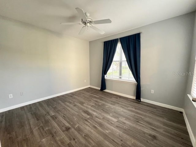 unfurnished room with ceiling fan and dark hardwood / wood-style floors