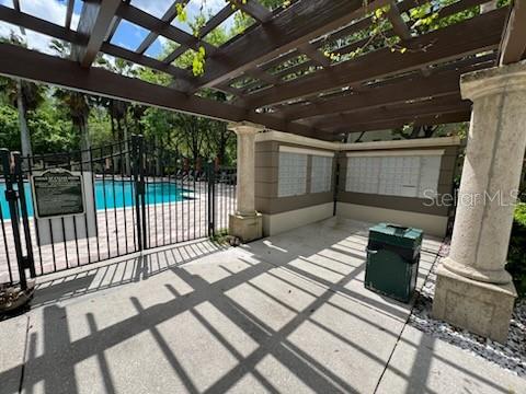 view of terrace featuring a pergola and a community pool