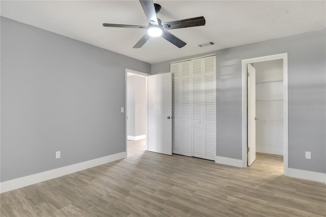 unfurnished bedroom featuring ceiling fan and light wood-type flooring