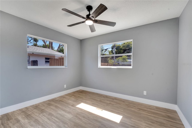 empty room featuring ceiling fan and hardwood / wood-style flooring