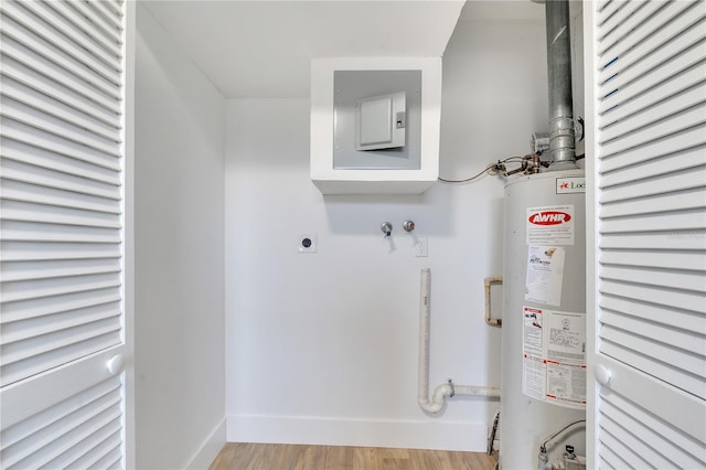 laundry room featuring hookup for a washing machine, light hardwood / wood-style floors, electric dryer hookup, and gas water heater