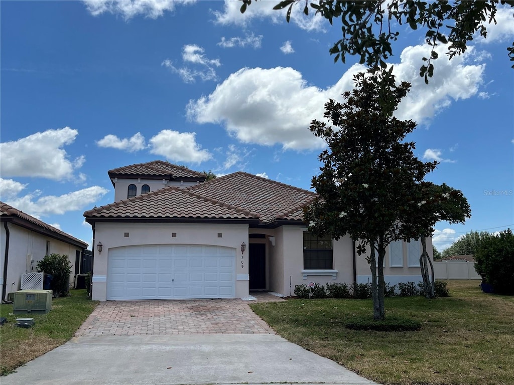 view of front of house with a front lawn and a garage