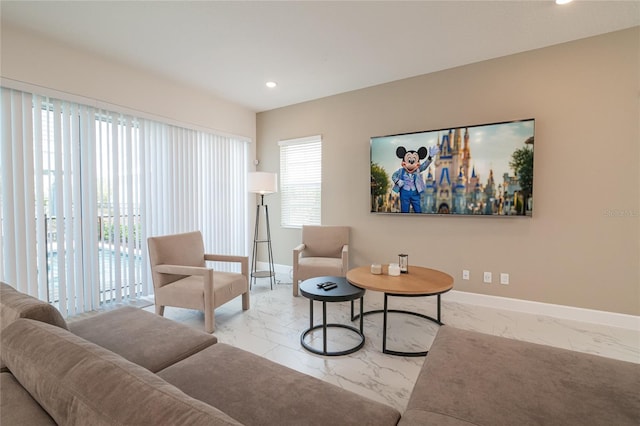 living room featuring light tile flooring and a wealth of natural light