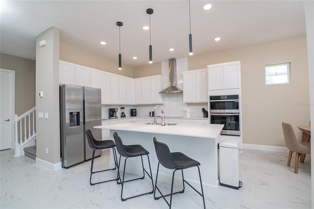 kitchen featuring wall chimney exhaust hood, stainless steel appliances, sink, and light tile flooring