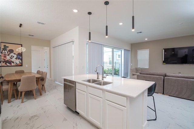 kitchen featuring a kitchen island with sink, sink, dishwasher, white cabinetry, and pendant lighting