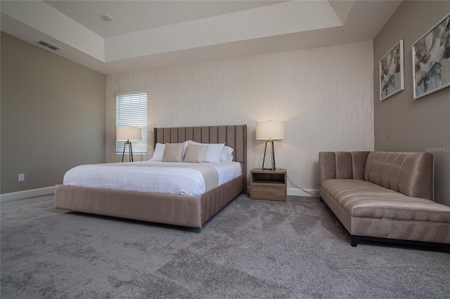 carpeted bedroom featuring a tray ceiling