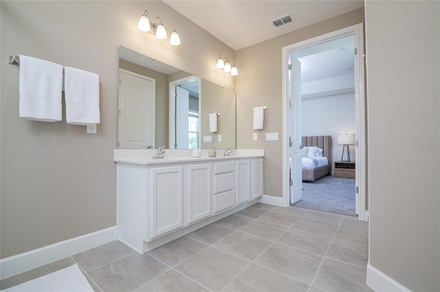 bathroom featuring large vanity, tile floors, and dual sinks