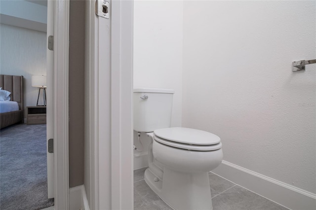 bathroom with tile flooring and toilet