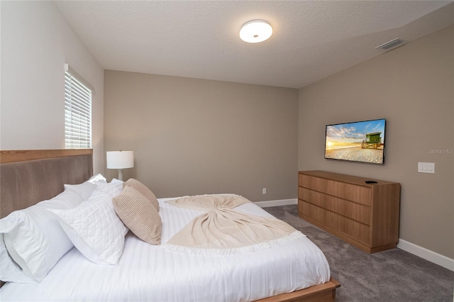 carpeted bedroom with a textured ceiling